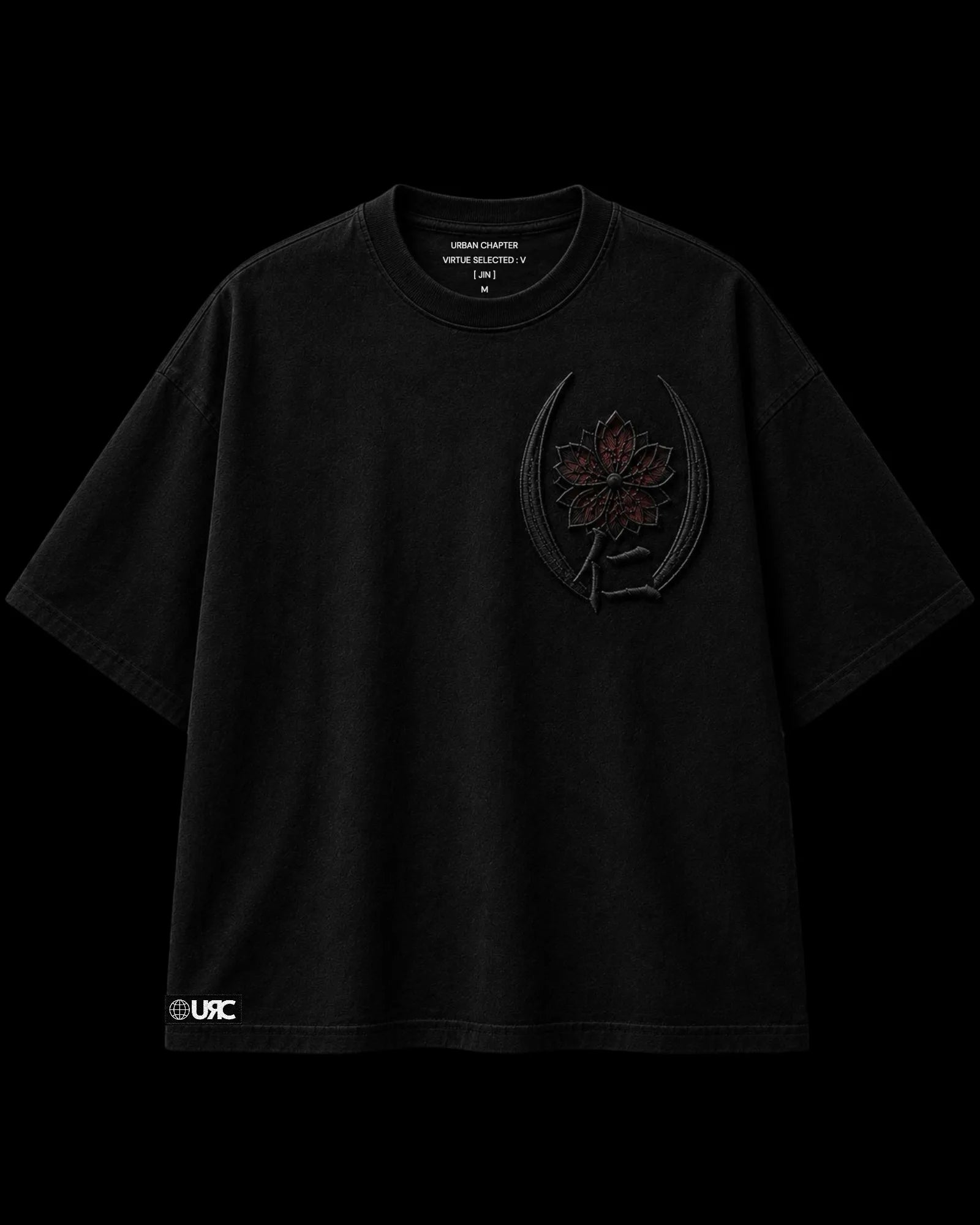 Front flat-lay of the JIN heavy black 260 GSM artifact, featuring a sculpted satin-embroidered sakura crest enclosed within twin crescent blades, representing the quiet strength of compassion protected by discipline. Finished with the signature Urban Chapter woven identity patch.